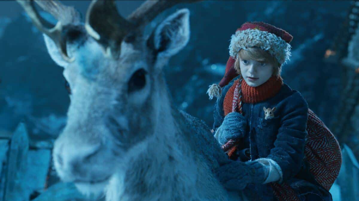 A boy called christmas still with boy sitting on a reindeer