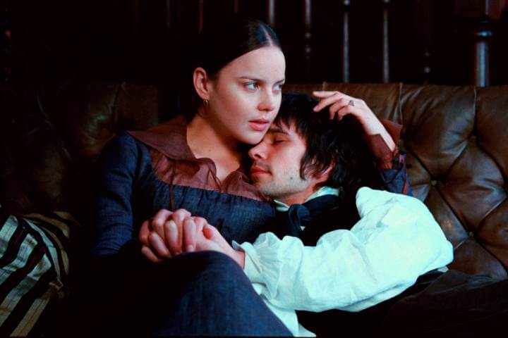 Bright Star promotional photo. The two actors are holding hands while sitting on a couch.