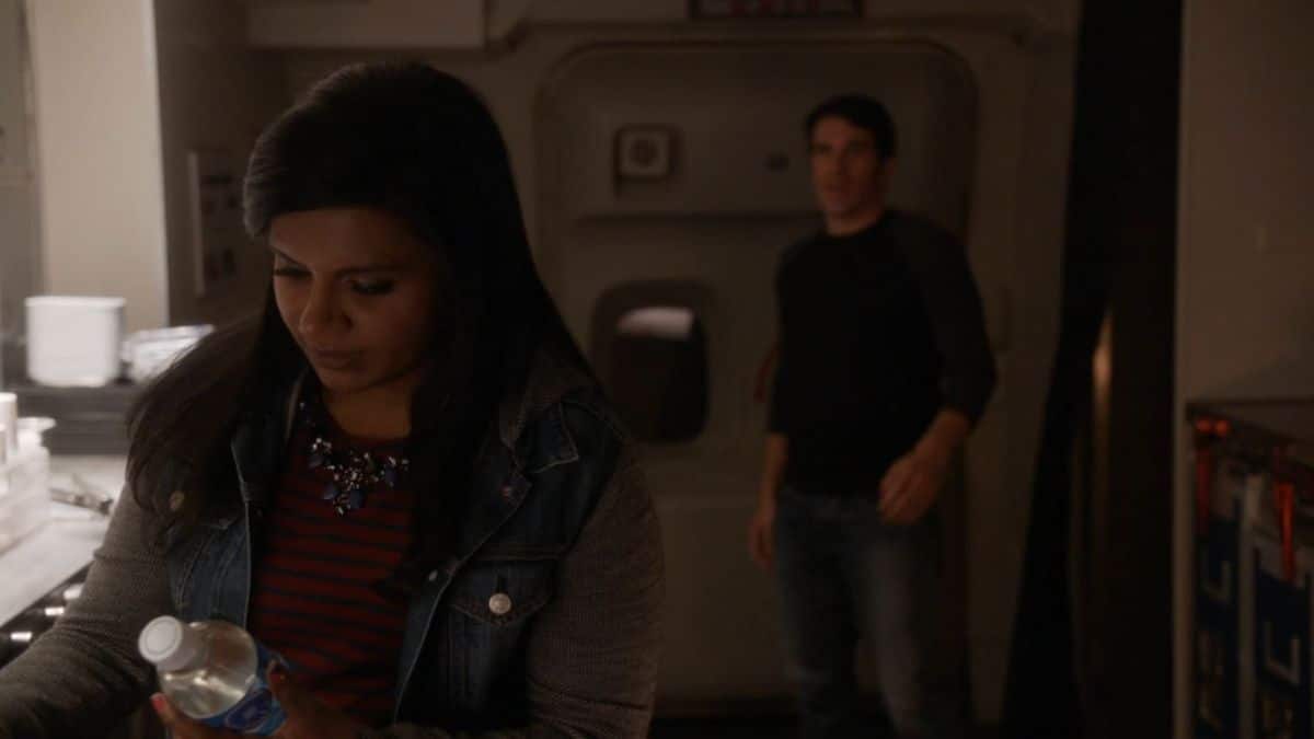 Danny walking toward Mindy on the plane.