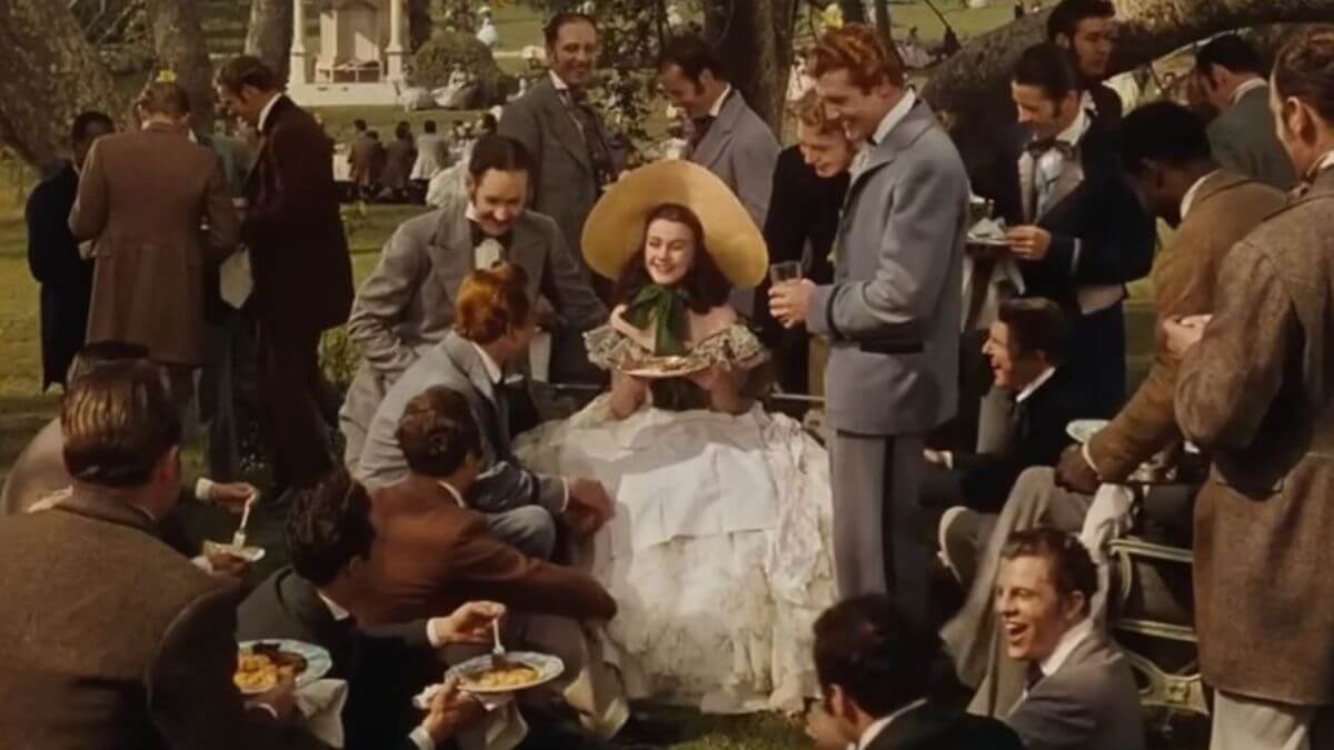 Scarlett O'Hara in Gone with the Wind wearing the green and white dress and a hat.