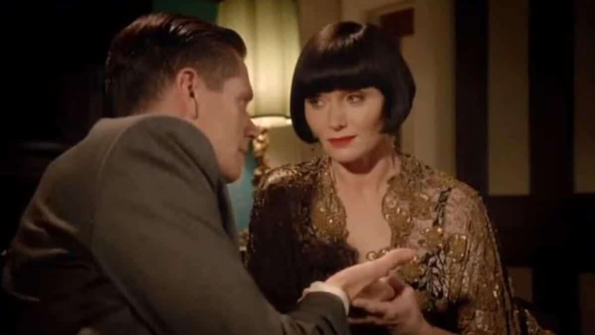 Phryne holds his hand while telling Jack's fortune.