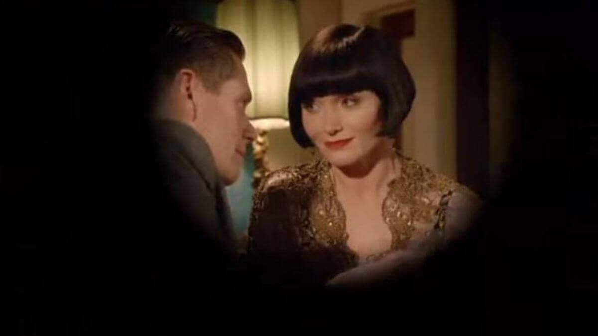 Jack and Miss Fisher look at each other in a romantic moment