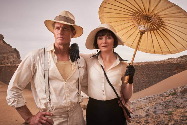 Miss Fisher and Jack outside with a parasol