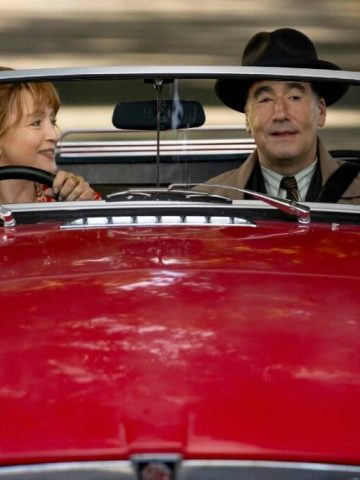 Susan Ryeland and Atticus Pünd in a red car