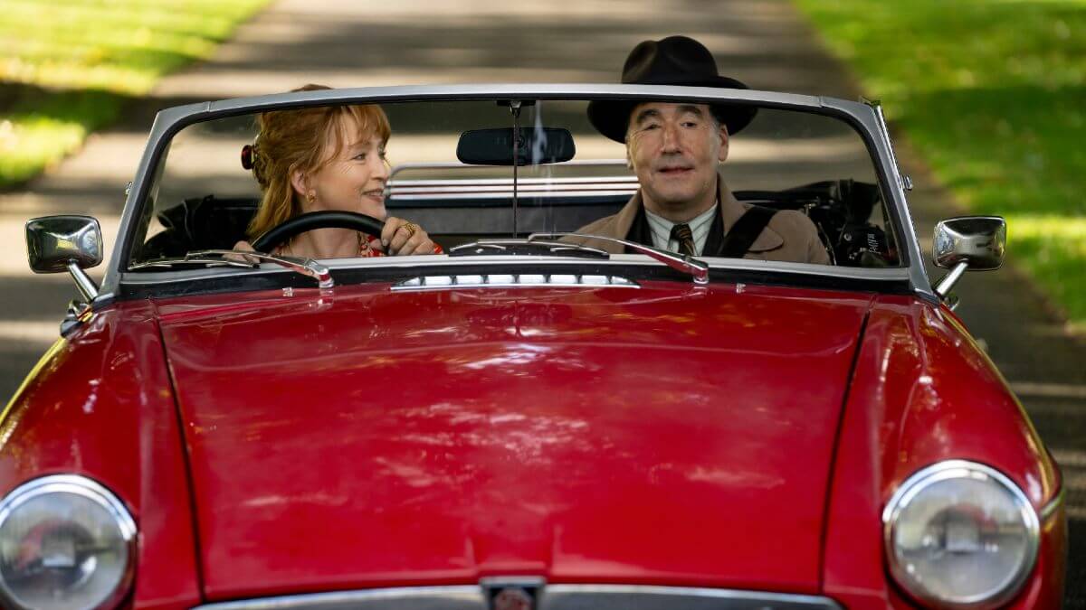 Susan Ryeland and Atticus Pünd in a red car