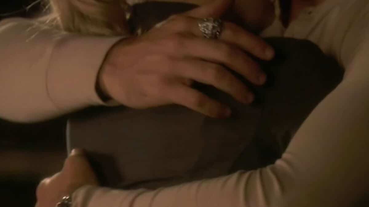 Mick and Beth hug in episode 1 - closeup of Mick's hands