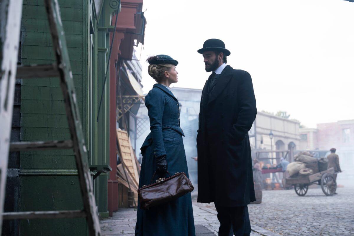 Miss Scarlet and the Duke publicity still. The pair are looking at each other outside. Tension felt.