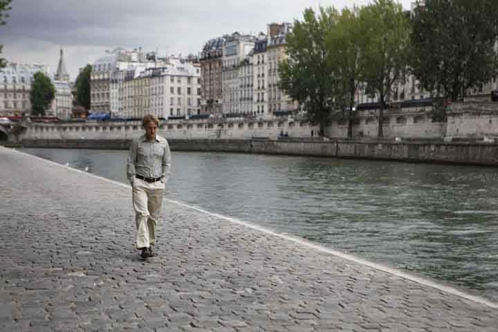 Gil strolling along the river in Midnight in Paris.