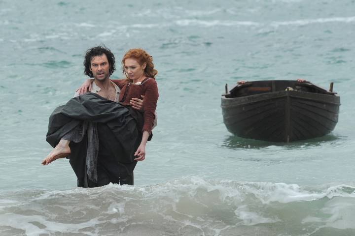 Ross carrying Demelza; shot taken at Kynance Cove