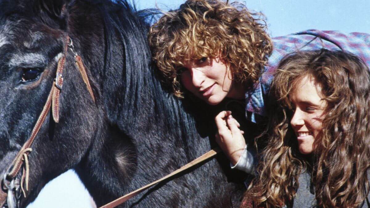 Red Dawn publicity still of Jennifer Grey and Lea Thompson with a horse