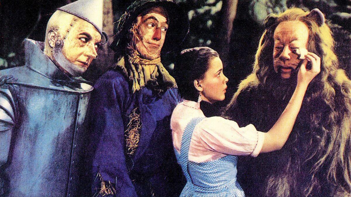 Tin Man, Scarecrow, Dorothy, and the Cowardly Lion from a lobby card.